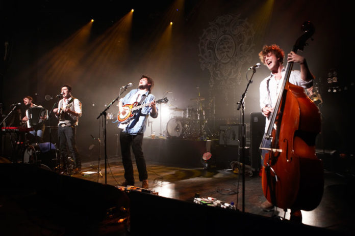 Mumford & Sons performing live on stage